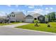 Charming single-Gathering home featuring a well-manicured lawn, an attached garage, and gray wood siding at 305 Forestbrook Cove Circle, Myrtle Beach, SC 29588
