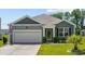 Charming one-story home with manicured lawn, attached garage, and inviting curb appeal at 305 Forestbrook Cove Circle, Myrtle Beach, SC 29588