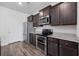 Modern kitchen features stainless steel appliances, dark wood cabinets, and granite countertops at 305 Forestbrook Cove Circle, Myrtle Beach, SC 29588