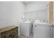 Efficient laundry room with modern washer and dryer units and storage at 305 Forestbrook Cove Circle, Myrtle Beach, SC 29588