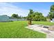 Expansive backyard featuring a well-maintained lawn, shed, mature trees, and concrete patio perfect for outdoor activities at 308 Sanders Ct., Mullins, SC 29574