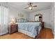 Charming bedroom features hardwood floors, ceiling fan, and a decorative headboard at 308 Sanders Ct., Mullins, SC 29574