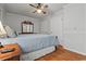 Comfortable bedroom with hardwood floors, ceiling fan, and a blue bedspread at 308 Sanders Ct., Mullins, SC 29574