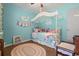 Whimsical bedroom featuring blue walls, a ceiling fan, and a decorative rug at 308 Sanders Ct., Mullins, SC 29574