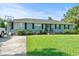 Inviting single-story home featuring a well-kept front lawn and a basketball hoop on driveway at 308 Sanders Ct., Mullins, SC 29574