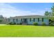 Well-maintained single-story home with a lush green lawn and mature landscaping at 308 Sanders Ct., Mullins, SC 29574