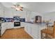 Open kitchen featuring barstool seating at a large island with custom tile counter, stainless appliances, and white cabinets at 308 Sanders Ct., Mullins, SC 29574