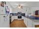 Bright kitchen featuring white cabinets, black appliances, tiled countertops, and ample counter space for cooking at 308 Sanders Ct., Mullins, SC 29574