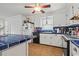 Well-lit kitchen with white cabinets, a tile backsplash, modern appliances, and an island with seating at 308 Sanders Ct., Mullins, SC 29574
