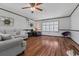 Relaxing living room featuring wood floors, ceiling fan, and abundant natural light at 308 Sanders Ct., Mullins, SC 29574