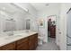 Bright bathroom featuring double sinks, wood cabinets, and a view into the walk in closet at 310 Lockerbie Ct. # 1057, Myrtle Beach, SC 29577