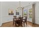 Charming dining room with hardwood floors, modern chandelier, and large windows providing natural light at 310 Lockerbie Ct. # 1057, Myrtle Beach, SC 29577