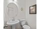 Cozy half bathroom with a pedestal sink, toilet, and decorative mirror at 310 Lockerbie Ct. # 1057, Myrtle Beach, SC 29577