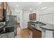 Well-equipped kitchen with stainless steel appliances, wooden cabinets, and a breakfast bar with a view of the dining area at 310 Lockerbie Ct. # 1057, Myrtle Beach, SC 29577