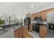 Modern kitchen featuring stainless steel appliances, a breakfast bar, and an open view to the living room at 310 Lockerbie Ct. # 1057, Myrtle Beach, SC 29577