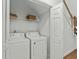 Convenient laundry closet with a washer, dryer, and shelving for storage, located near the staircase at 310 Lockerbie Ct. # 1057, Myrtle Beach, SC 29577