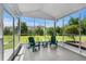 View of screened in back porch with seating and view of the backyard at 310 Lockerbie Ct. # 1057, Myrtle Beach, SC 29577