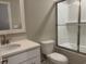 Bright bathroom featuring a white vanity, a toilet, and a tiled shower at 3137 Tiger Tail Rd., Conway, SC 29526