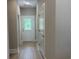 Bright hallway featuring wood-look flooring, neutral paint, and a glass-paneled door leading to the outdoors at 3137 Tiger Tail Rd., Conway, SC 29526