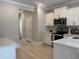 Modern kitchen with white cabinets, stainless appliances, and a tiled backsplash at 3137 Tiger Tail Rd., Conway, SC 29526