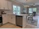 Bright kitchen with white cabinetry, stainless appliances, and bar stool seating at 3137 Tiger Tail Rd., Conway, SC 29526
