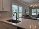 Close-up of a kitchen sink featuring a stainless faucet and a backsplash with an interesting design at 3137 Tiger Tail Rd., Conway, SC 29526