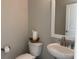 Neat powder room featuring a pedestal sink, toilet, and white framed mirror at 3137 Tiger Tail Rd., Conway, SC 29526