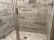 Modern shower featuring neutral tile, glass doors, and a built-in niche at 3137 Tiger Tail Rd., Conway, SC 29526