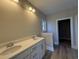 Bathroom featuring a double vanity, quartz countertop, modern lighting, and a separate closet at 3139 Tiger Tail Rd., Conway, SC 29526