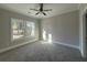 Cozy bedroom with plush carpeting, ceiling fan and a bright window offering natural light at 3139 Tiger Tail Rd., Conway, SC 29526