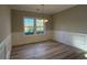 Formal dining room with a modern chandelier, hardwood flooring, and natural light from the window at 3139 Tiger Tail Rd., Conway, SC 29526