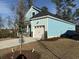 Side view of a charming light blue home with a two-car garage and newly landscaped yard at 3139 Tiger Tail Rd., Conway, SC 29526