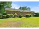 Expansive backyard with lush green grass, mature trees, and brick exterior, perfect for outdoor activities at 324 Camellia Ave., Marion, SC 29571