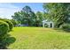 Backyard featuring a large grassy area, a shed, and mature trees at 324 Camellia Ave., Marion, SC 29571