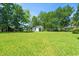 Backyard featuring a large grassy area, a shed, and mature trees at 324 Camellia Ave., Marion, SC 29571