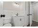 Bright bathroom with white tile, modern sink and vanity featuring black hardware at 324 Camellia Ave., Marion, SC 29571