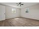 Bedroom with two windows and a ceiling fan with luxury vinyl plank flooring at 324 Camellia Ave., Marion, SC 29571