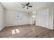 Bedroom with luxury vinyl plank flooring, ceiling fan, and access to the vanity area at 324 Camellia Ave., Marion, SC 29571