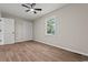 Inviting bedroom featuring new floors, ceiling fan and natural light from the window at 324 Camellia Ave., Marion, SC 29571