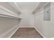 Walk-in closet featuring custom shelving and luxury vinyl plank flooring at 324 Camellia Ave., Marion, SC 29571