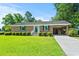 Inviting brick home with a pristine lawn, complemented by a covered carport, blending functionality and curb appeal at 324 Camellia Ave., Marion, SC 29571
