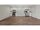Bright kitchen with new stainless steel appliances, white cabinetry, and wood floors at 324 Camellia Ave., Marion, SC 29571