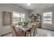 Dining area featuring large windows, neutral decor, and a stylish table setting at 339 Garden Grove St, Conway, SC 29526