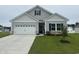 Charming single-story home features a two-car garage, manicured lawn, and stylish gray siding at 339 Garden Grove St, Conway, SC 29526