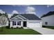 Charming single-story home featuring a two-car garage, well-maintained lawn, and inviting curb appeal at 339 Garden Grove St, Conway, SC 29526