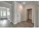 Inviting home hallway featuring hardwood floors, neutral walls, and a stylish rug at 339 Garden Grove St, Conway, SC 29526