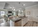 Open-concept kitchen island with granite countertops and stainless steel appliances overlooking the living area at 339 Garden Grove St, Conway, SC 29526
