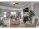 Inviting living room featuring a fireplace, ceiling fan, and an adjacent dining area at 339 Garden Grove St, Conway, SC 29526