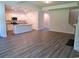 Open-concept living space with wood-look floors and a view of the modern kitchen at 339 Garden Grove St, Conway, SC 29526