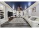 Spacious finished basement with dark blue ceiling, large TV, and white leather seating at 350 Saint Julian Ln., Myrtle Beach, SC 29579